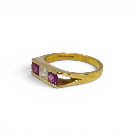 18ct yellow gold ruby and diamond ring by Reeves and Sons, featuring a central ruby gemstone and sparkling diamonds.