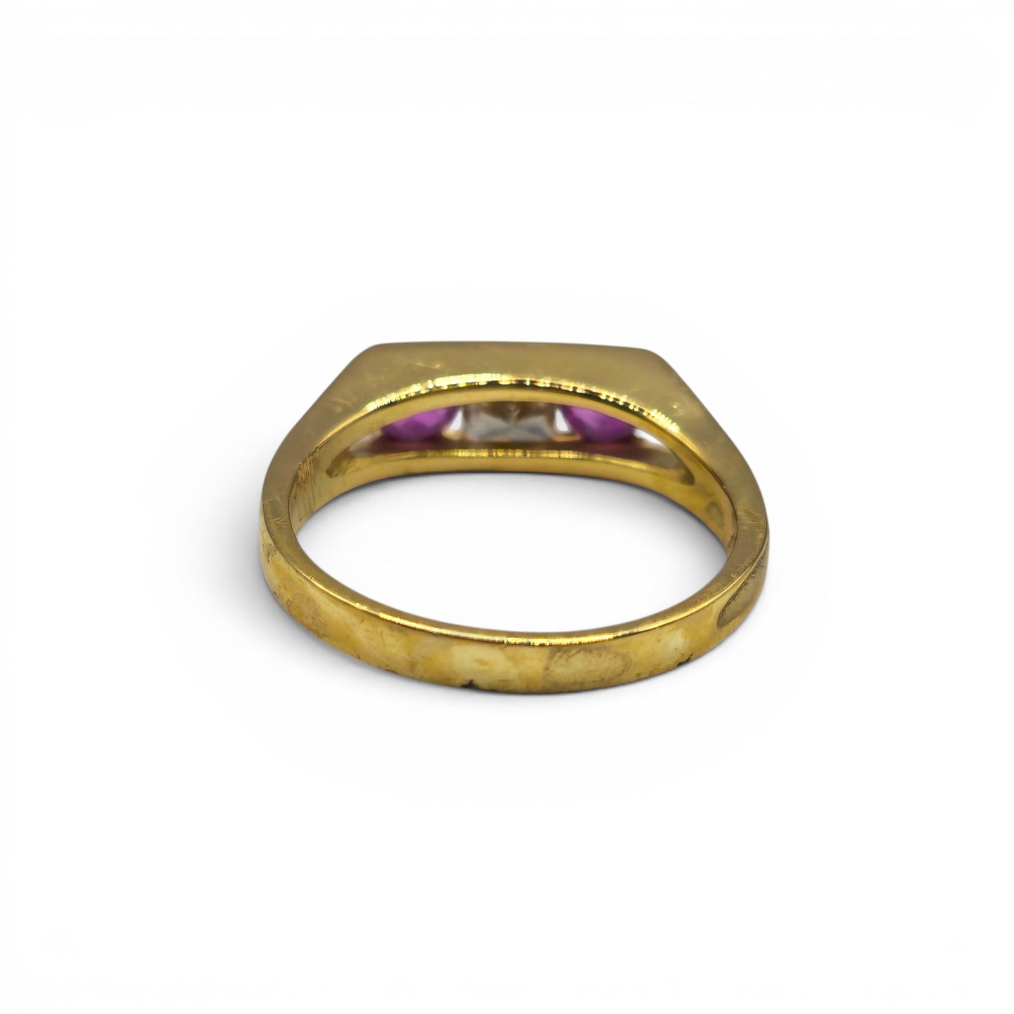 18ct yellow gold ruby and diamond ring by Reeves and Sons, featuring a central ruby surrounded by sparkling diamonds.
