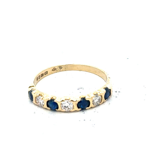 18ct yellow gold diamond and sapphire ring, size M 1/2, featuring a gold band with sparkling diamonds and vibrant sapphires.