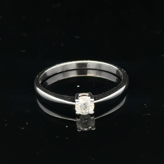 18ct white gold diamond ring with 1/4 carat center stone, size P 1/2, featuring a sleek and elegant design.