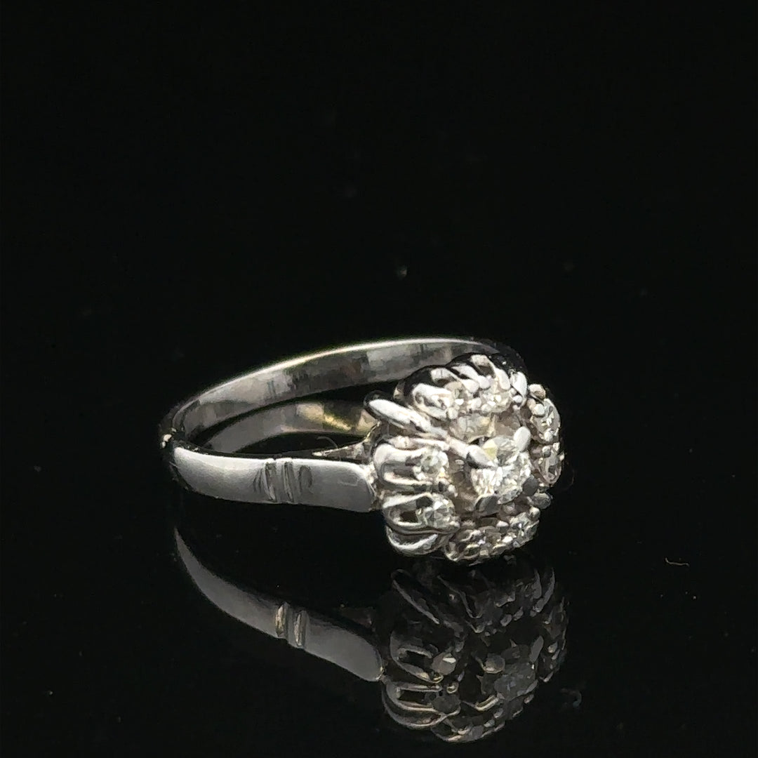 9ct white gold cluster diamond ring by Reeves and Sons, showcasing a sparkling diamond cluster setting on a sleek band.
