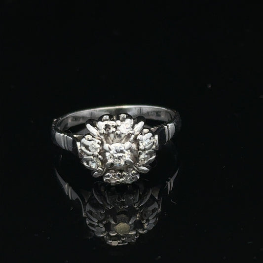 9ct white gold cluster diamond ring by Reeves and Sons featuring sparkling diamonds in a elegant design.