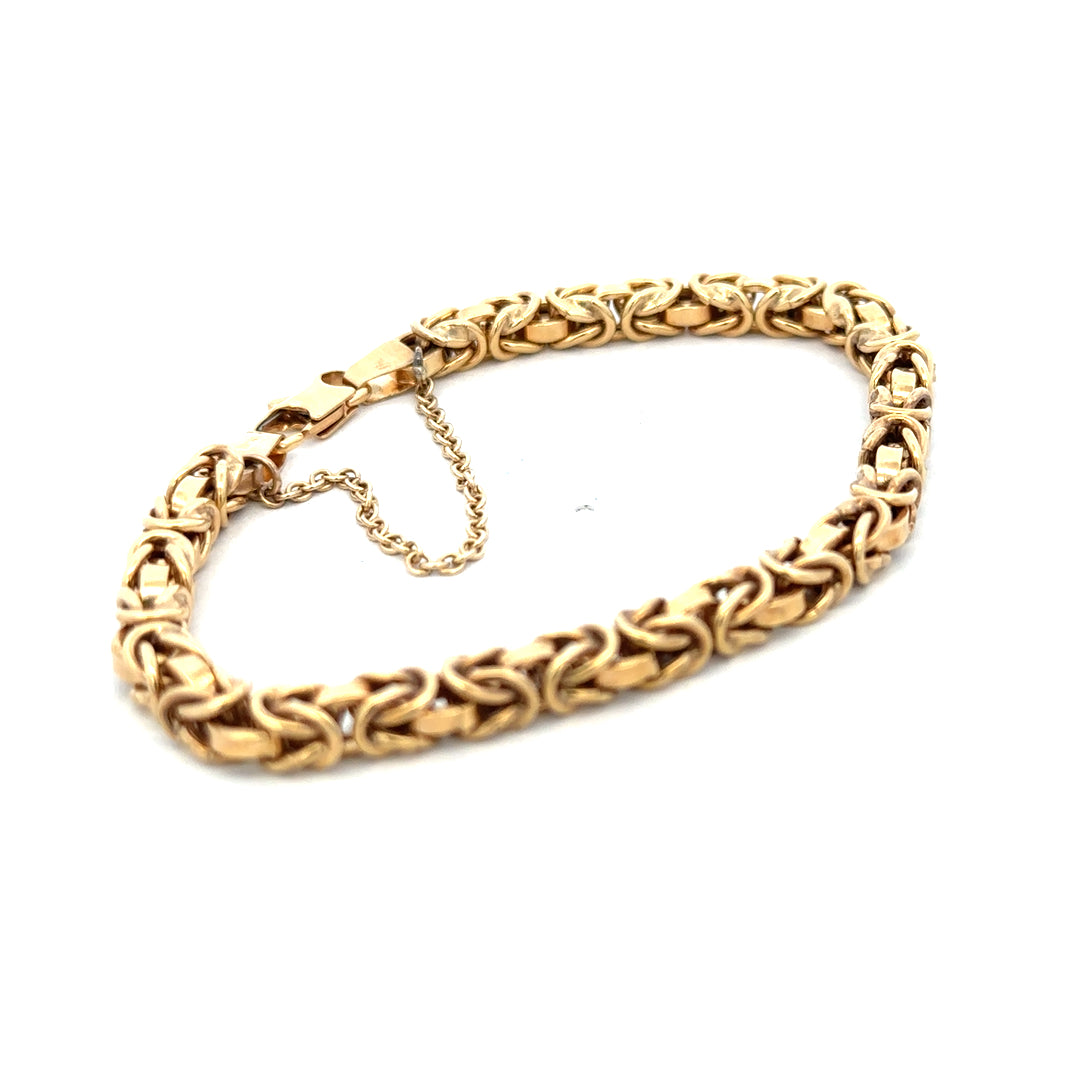 9ct yellow gold bracelet weighing 10.8g, featuring a delicate chain design, from Reeves and Sons.