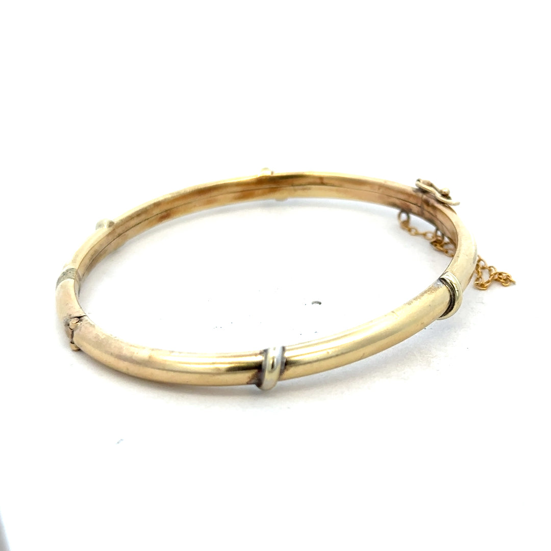 9ct yellow gold bangle weighing 11.1g, featuring a smooth, polished finish and elegant design from Reeves and Sons.
