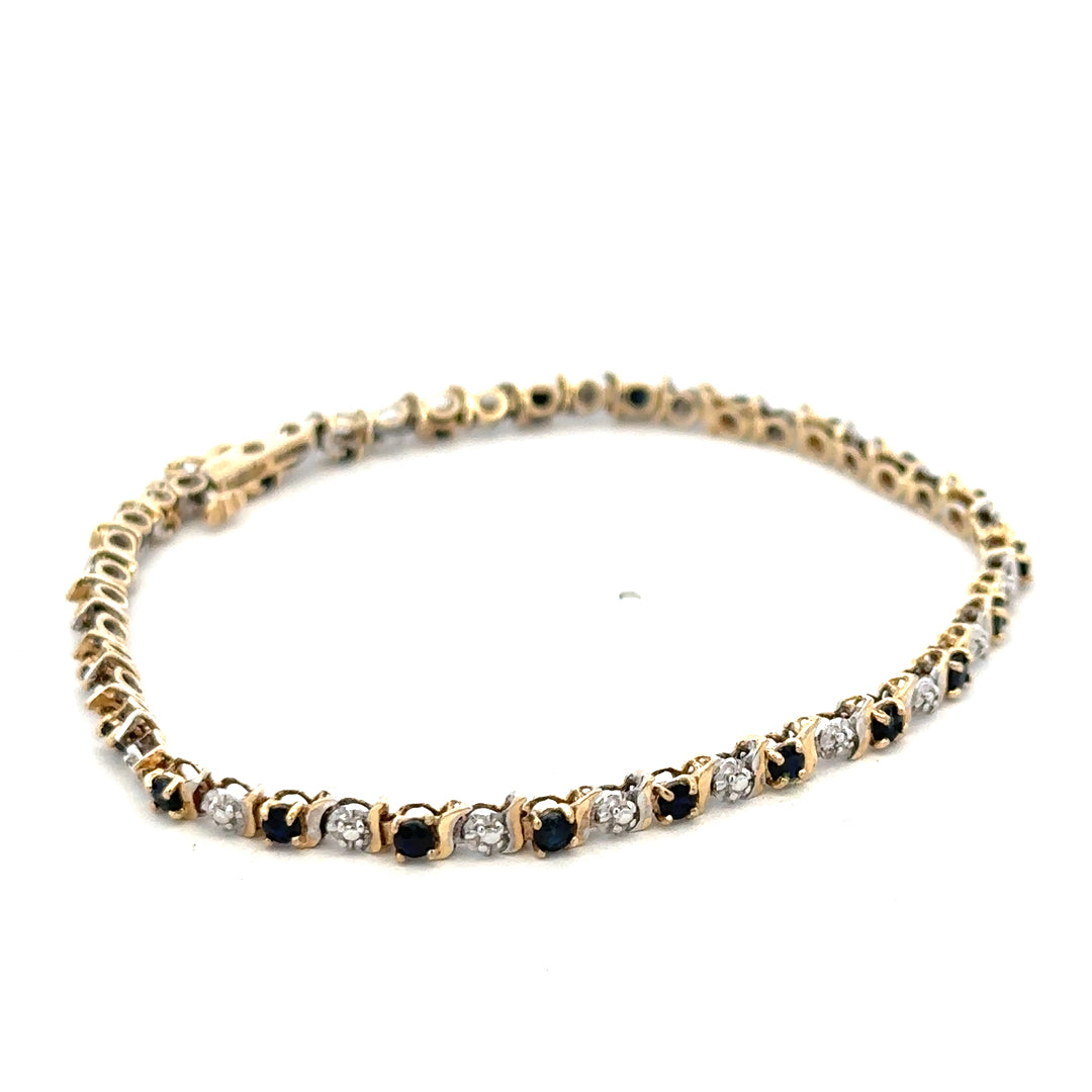 9ct yellow gold sapphire and diamond bracelet with intricate design, weighing 4.8g, crafted by Reeves and Sons.