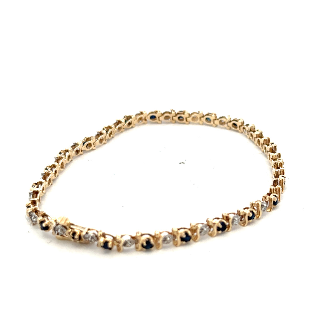 9ct yellow gold sapphire and diamond bracelet with intricate design, weighing 6.5g, crafted by Reeves and Sons.