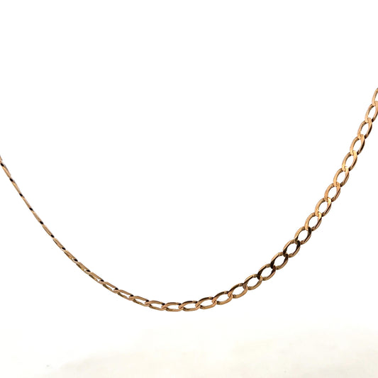 9ct yellow gold curb chain weighing 7.6g, with a detailed close-up showing its links and shine.