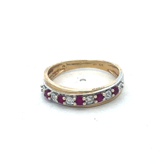 9ct yellow gold ruby and diamond ring by Reeves and Sons, showcasing a vibrant ruby centerpiece surrounded by sparkling diamonds.