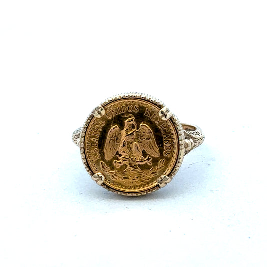 9ct gold Dos Pesos ring by Reeves and Sons, showcasing intricate design and craftsmanship in a close-up view.