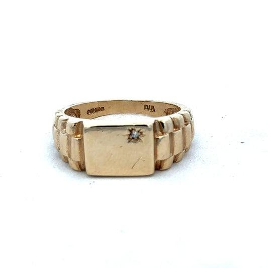 9ct yellow gold diamond ring by Reeves and Sons, featuring a sparkling diamond set in a polished gold band.