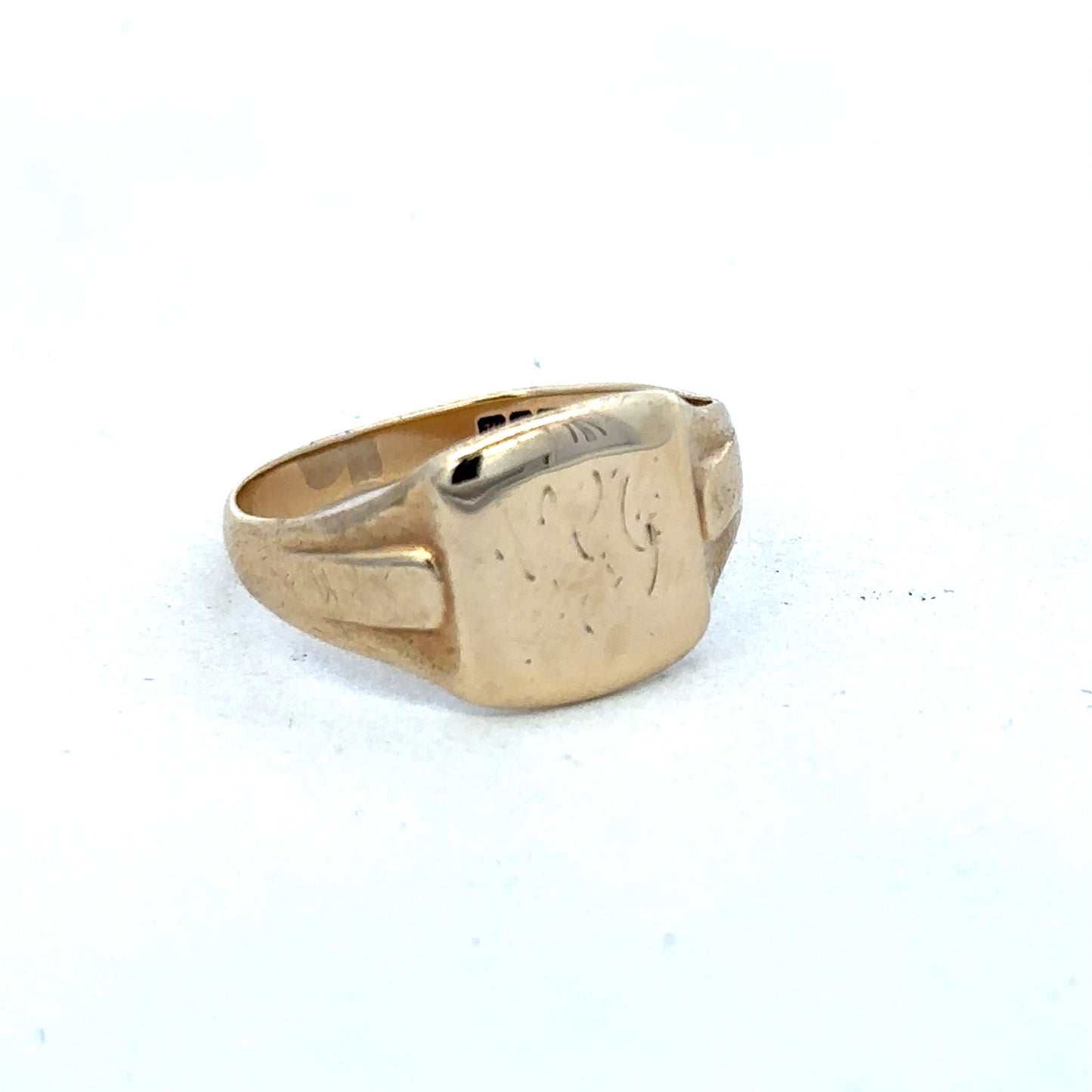 9ct yellow gold ring by Reeves and Sons, showcasing a polished band with subtle design details.