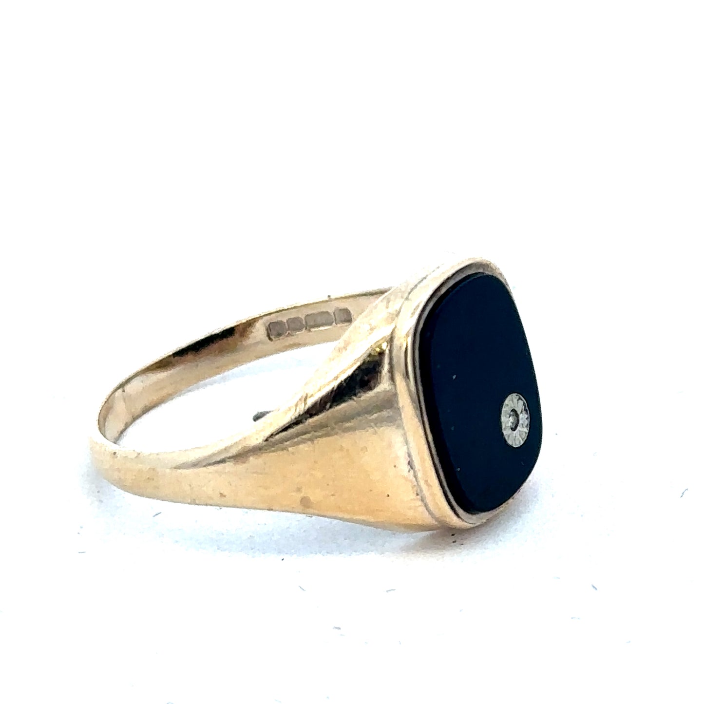 9ct yellow gold signet ring in size T by Reeves and Sons, showing the polished gold surface and classic design.