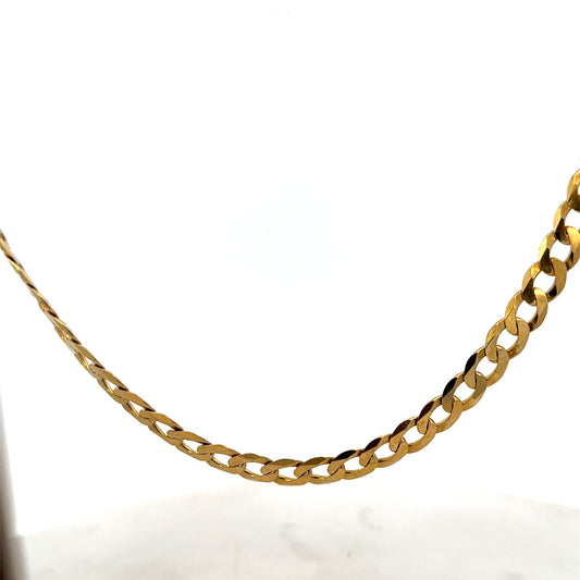 9ct yellow gold curb chain weighing 26.5g from Reeves and Sons, showing its links and polished finish.