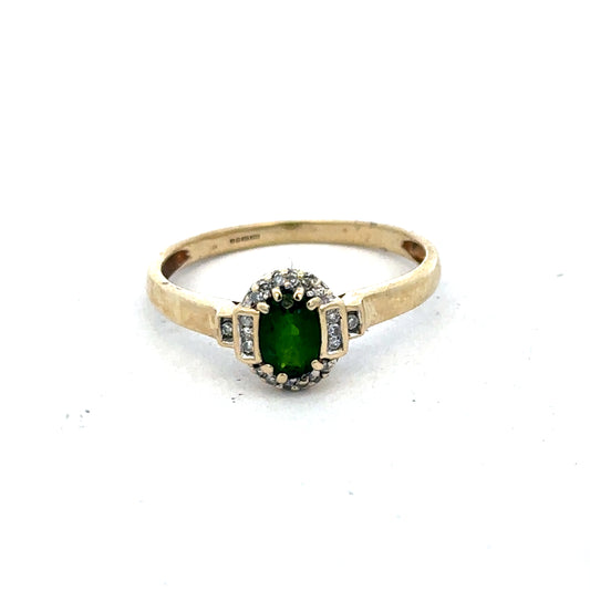 9ct yellow gold emerald and diamond ring by Reeves and Sons, size R, featuring a central emerald and sparkling diamonds.
