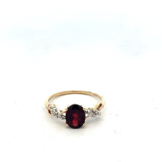 9ct yellow gold garnet and diamond ring in size R1/2, featuring intricate design by Reeves and Sons.