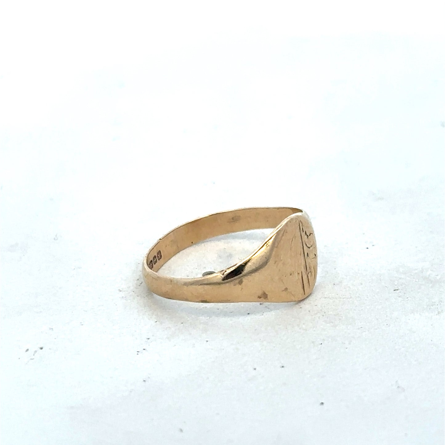 9ct yellow gold signet ring in size M from Reeves and Sons, featuring a smooth polished surface and classic design.