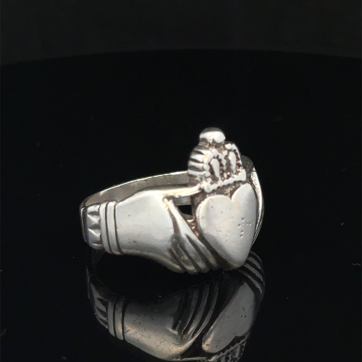 Silver Claddagh ring in size Z1 by Reeves and Sons, featuring detailed craftsmanship and symbolic heart and hands design.