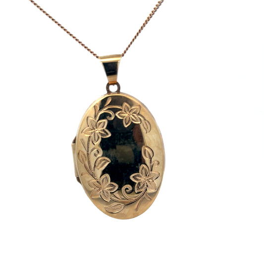 9ct yellow gold locket pendant weighing 4.2g, crafted by Reeves and Sons, featuring a smooth, polished surface with decorative details.