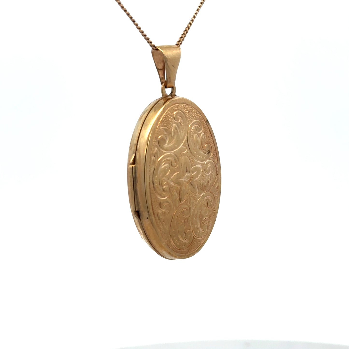 9ct yellow gold locket pendant by Reeves and Sons, shown with intricate design and polished finish, weighing 4.4g.