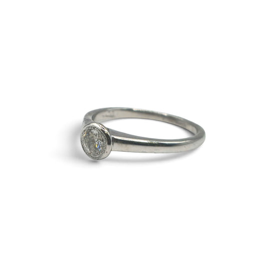 18ct white gold diamond solitaire ring by Reeves and Sons featuring a single sparkling diamond setting.