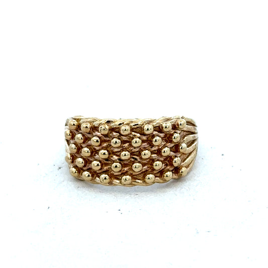 9ct yellow keeper ring size M by Reeves and Sons, close-up of gold ring with smooth finish and detailed band design.
