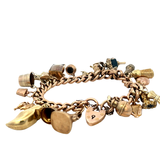 Reeves and Sons 9ct yellow gold charm bracelet with intricate detailing, weighing 46.8g, shown in close-up image.