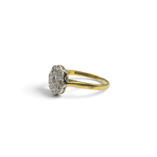 18ct yellow gold diamond cluster ring by Reeves and Sons, featuring a sparkling diamond design on a polished gold band.