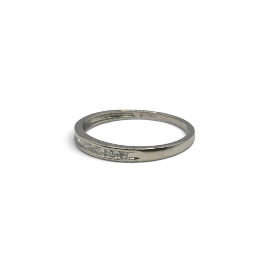 Platinum half eternity ring with sparkling gemstones by Reeves and Sons, showcasing a sleek band design.