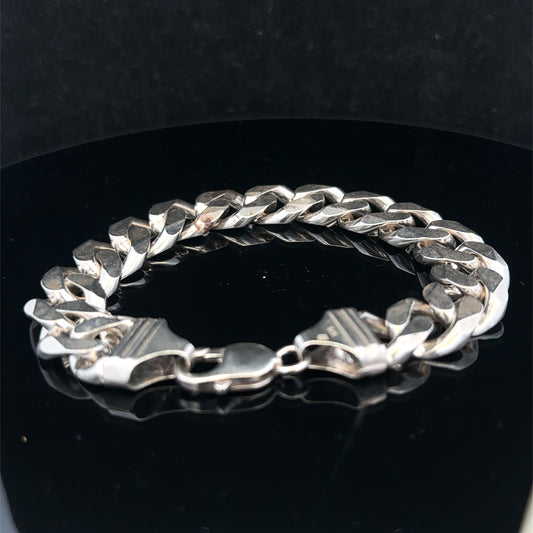 Silver curb bracelet by Reeves and Sons, 68.4g, showcasing a polished chain link design on a plain background.