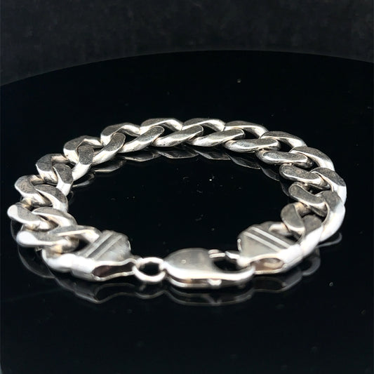 Silver curb bracelet weighing 43.8g by Reeves and Sons, featuring interlinked flat chain links on a plain background.