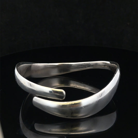 Silver bangle weighing 45.1g from Reeves and Sons, showcasing a polished, sleek jewelry piece with intricate details.