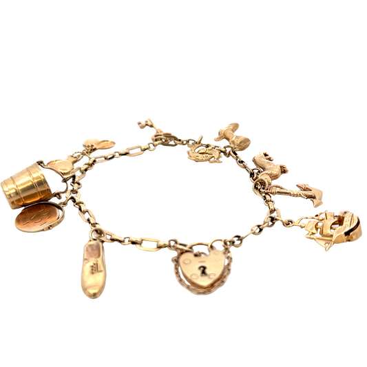 9ct yellow gold charm bracelet by Reeves and Sons, 16.3g; assorted charms on a linked chain