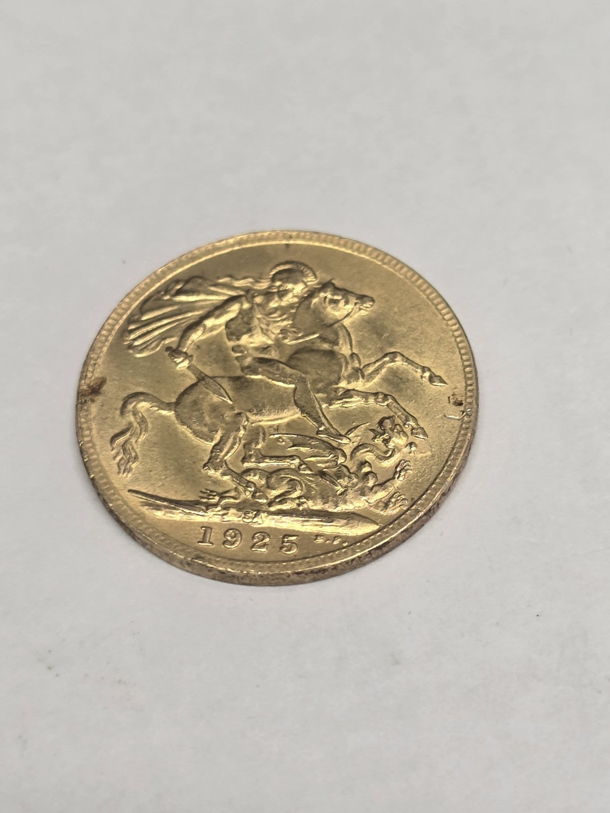 1925 Reeves and Sons full sovereign coin displaying detailed portrait and denomination, weighing 8 grams.