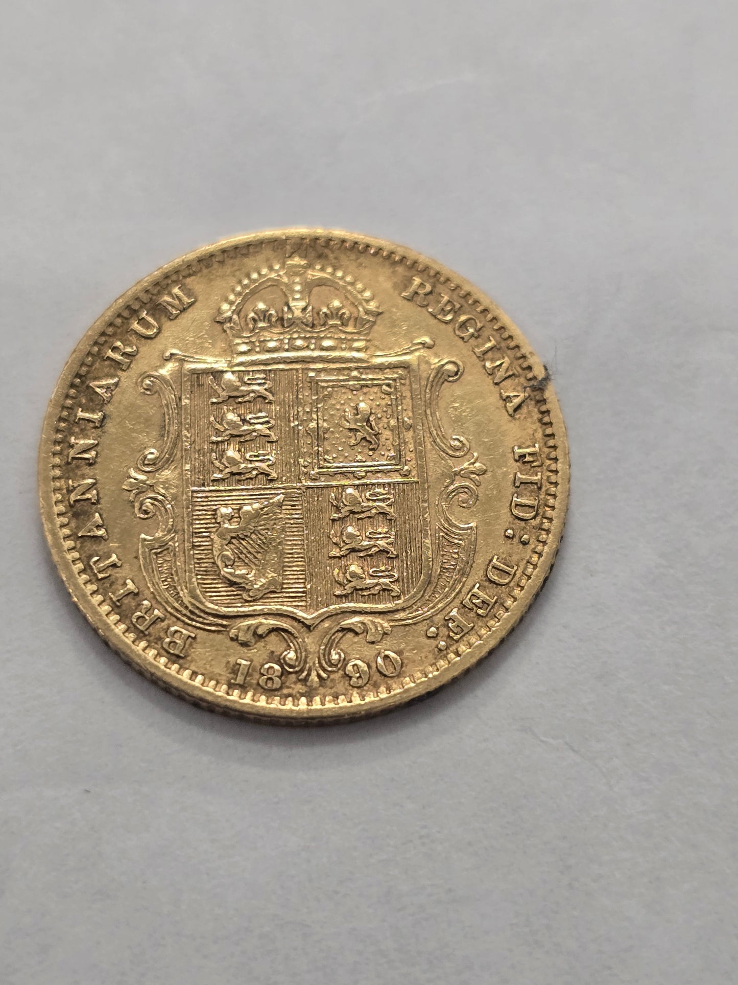 Gold coin featuring Queen Victoria, 1890 Half Sovereign, Reeves and Sons, with detailed portrait and ornate design.