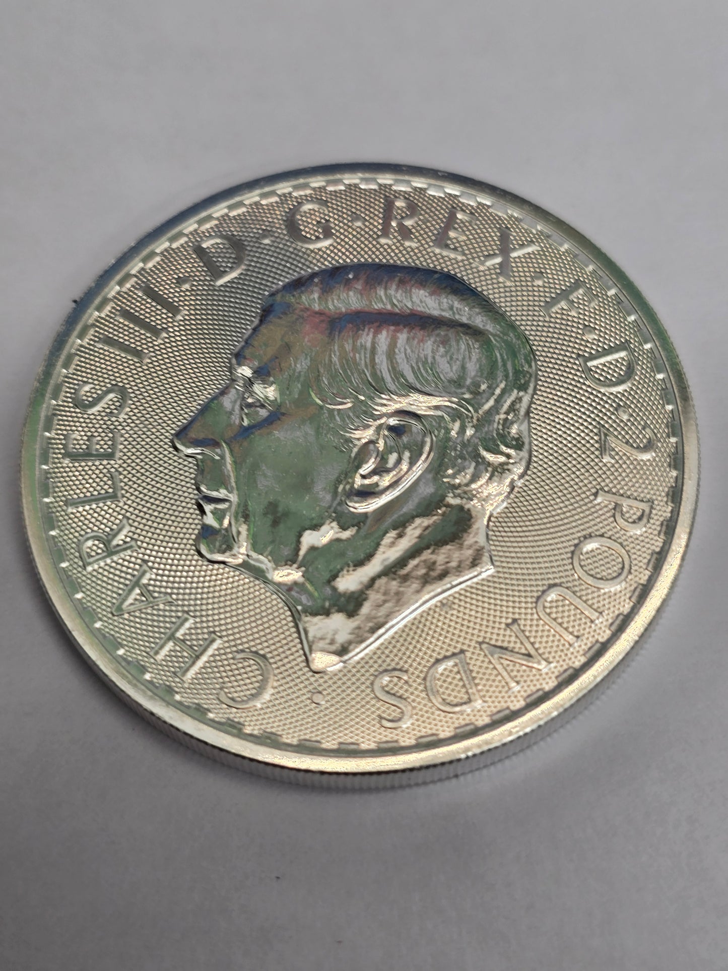 Silver 1oz 2025 Britannia coin by Reeves and Sons, featuring the £2 denomination and fine 999 silver finish.