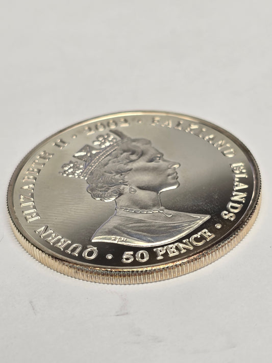 Silver 50 pence Golden Jubilee coin from 2002 by Reeves and Sons, featuring detailed Jubilee design and inscriptions.