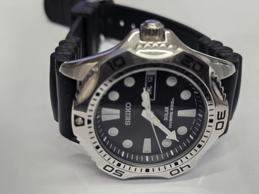 Seiko Solar Air Divers 200m watch with black dial, stainless steel band, and rotating bezel for diving and sports use