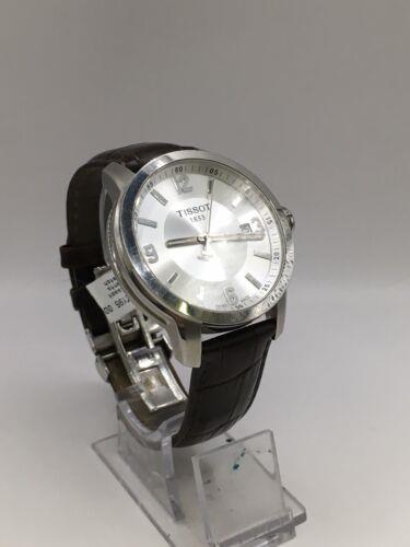 Elegant Tissot gents watch with a stainless steel band and classic round dial, showcasing sophisticated Swiss craftsmanship.