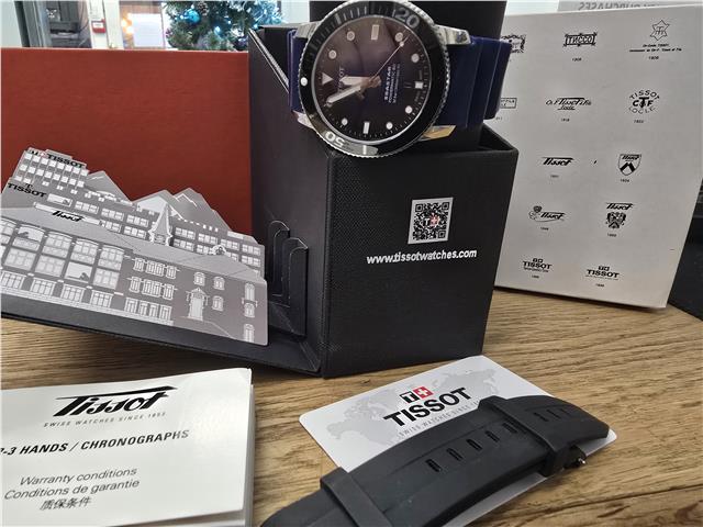 Tissot Seastar Power Matic 80 watch with boxed papers, featuring a stainless steel case and black dial.