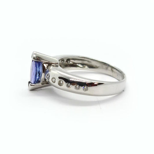 14ct gold ring featuring 0.85 carats of Tanzanite and diamond accents, elegant jewelry piece with a polished band