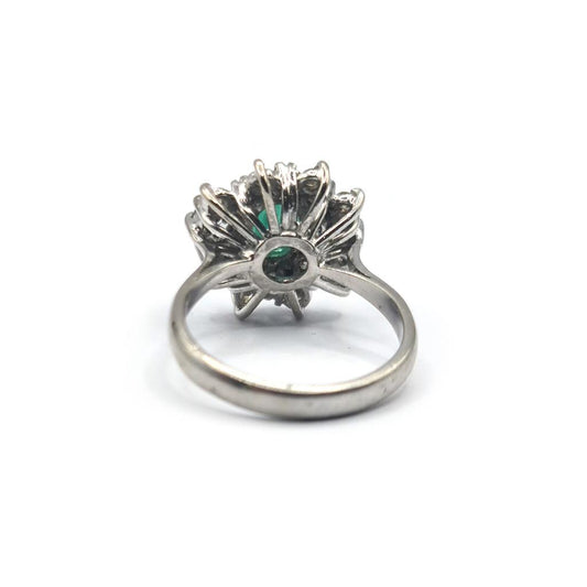18ct gold ring with a 0.65 carat emerald and 1.15 carat diamond, featuring a elegant, sparkling gemstone design.