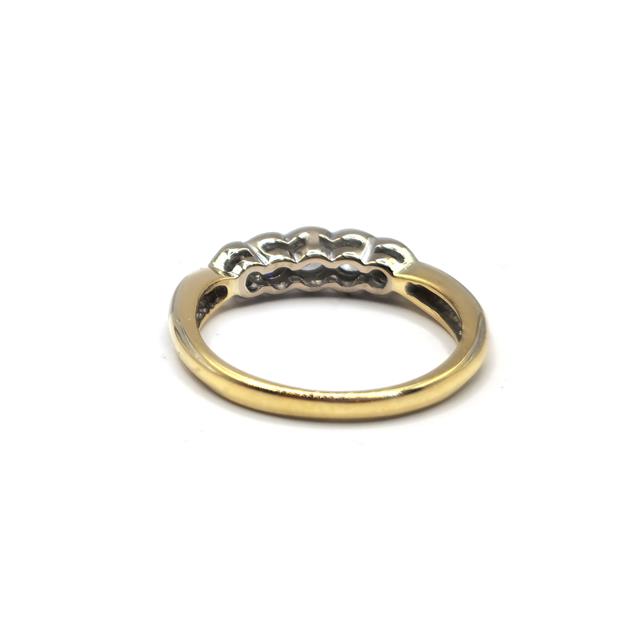 Elegant 18ct diamond ring with a sparkling central diamond and a sleek band, unbranded jewelry piece.