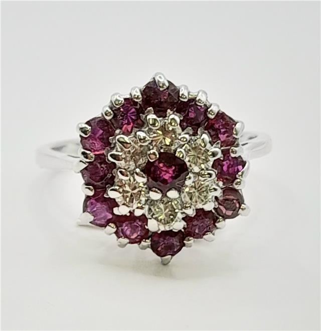 18ct white gold diamond and ruby ring with a central gemstone and intricate band design, unbranded jewelry piece.