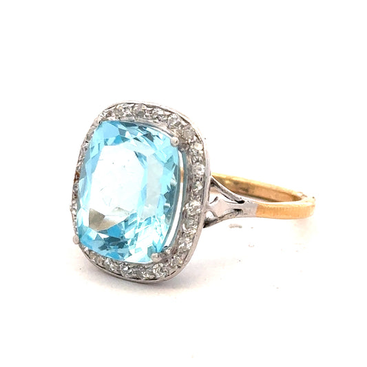 18ct yellow gold ring with a 10.70 carat topaz and 0.40 carat diamonds, size R, featuring an elegant gemstone design.