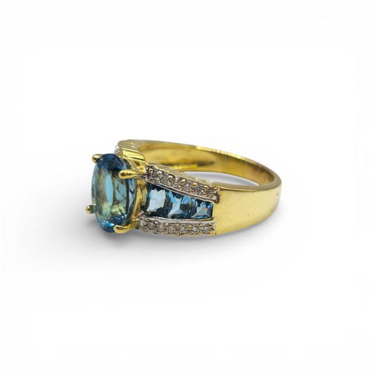 18ct yellow gold ring with sparkling diamonds and blue topaz gemstone, elegant jewelry piece featuring intricate design.