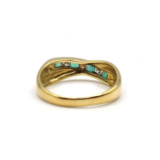 18ct yellow gold emerald and diamond half eternity ring with alternating gemstones and delicate band design.
