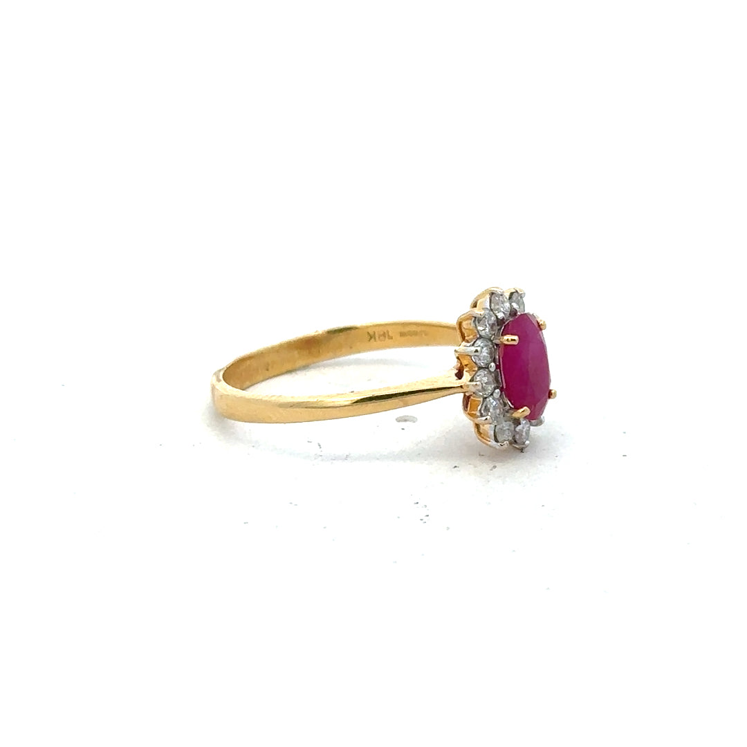 18ct yellow gold ruby and diamond ring size P, featuring a central ruby with diamond accents, elegant jewelry design.
