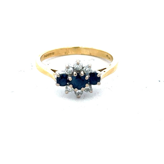 18ct yellow gold sapphire and diamond ring in size K, featuring a central sapphire surrounded by sparkling diamonds.