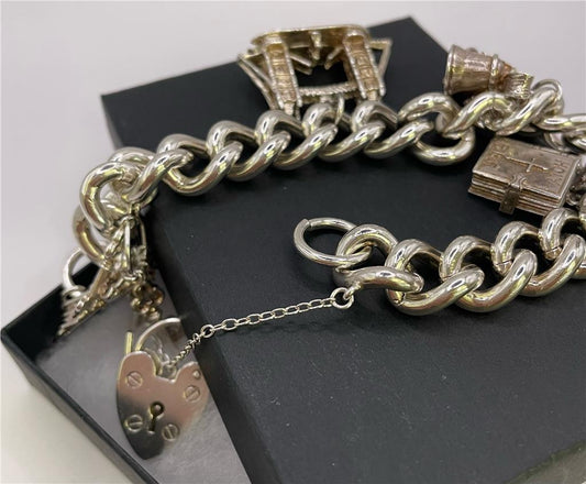 925 silver charm bracelet with intricate charms and adjustable chain, designed for a stylish and elegant look.