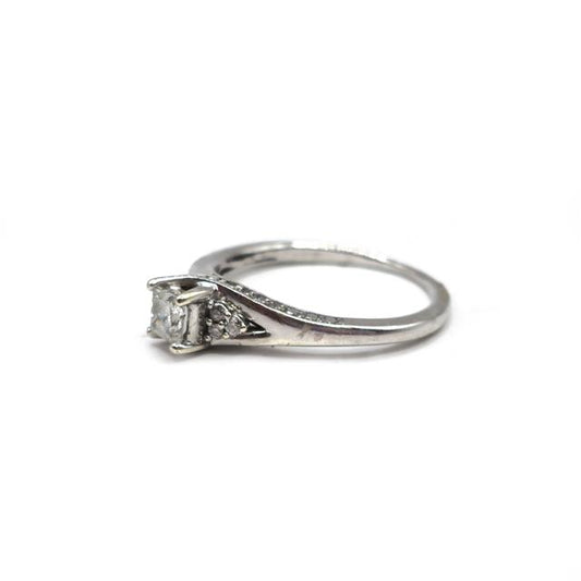 9ct white gold diamond ring with a central sparkling diamond and a sleek band design.
